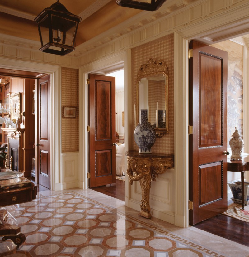 marble tile foyer gold gilt ceramic stand. Beautiful polished wood doors charles edwards hardware