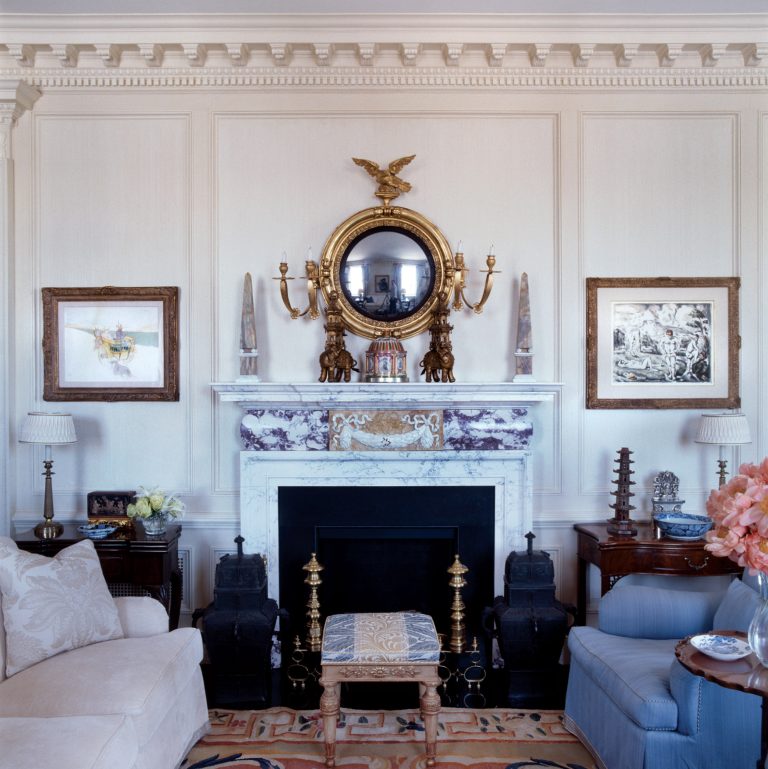 Georgian style marble fireplace design in a NYC apartment with a nautical mirror